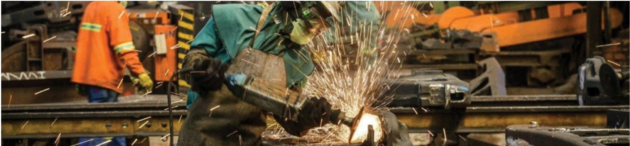 Worker grinding steel
